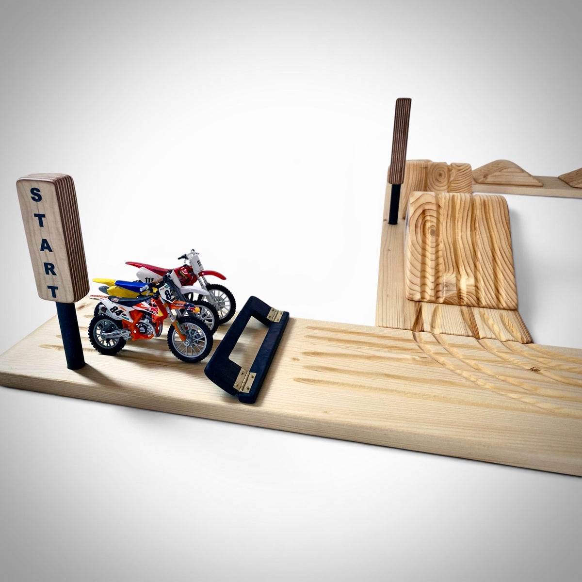 Premium handcrafted wooden dirt bike play track made from solid wood with natural finish.