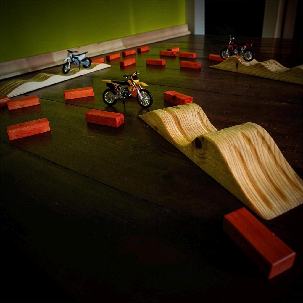 Dirt bike toy track with multiple motocross jumps for kids