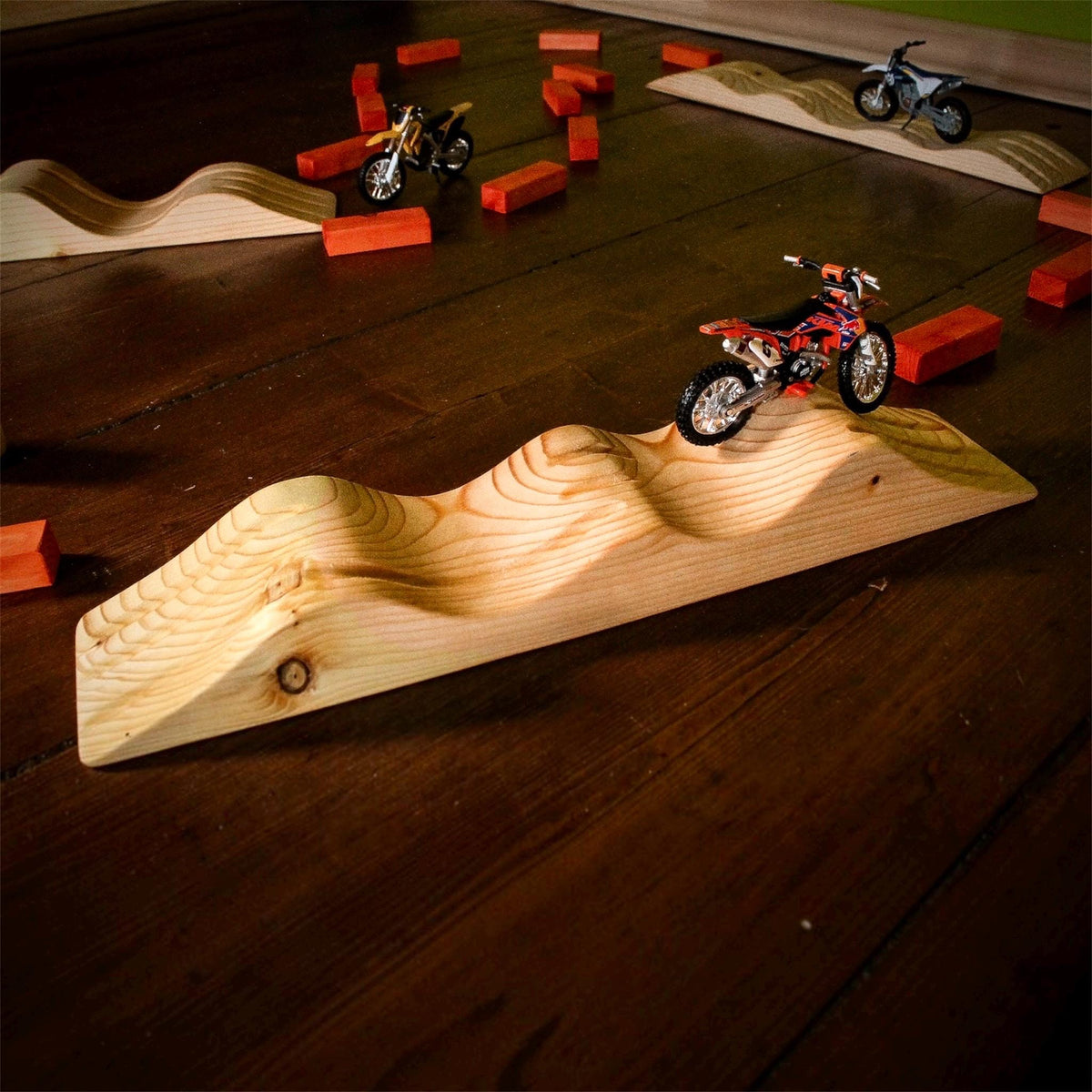Motocross playset with wooden dirt bike track and jumps