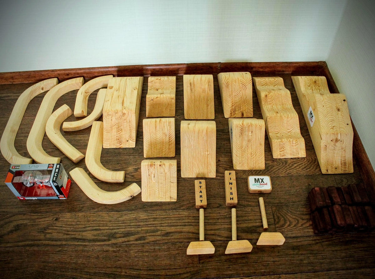 Close-up of handmade wooden dirt bike jumps made from solid spruce wood with natural wood grain.