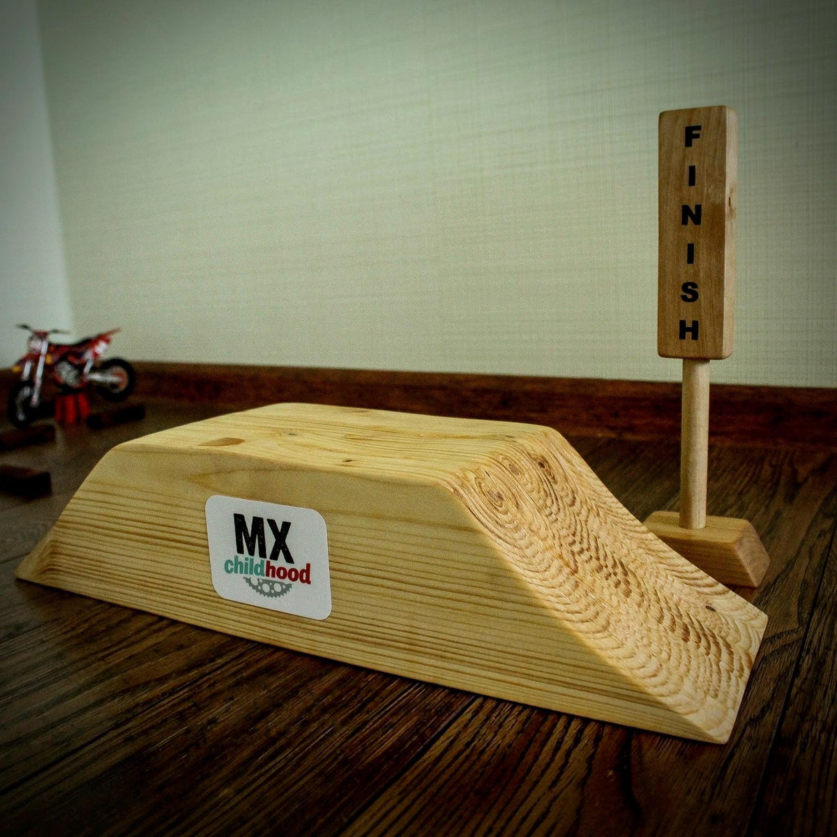 Kids wooden motocross track designed for exciting miniature dirt bike races, featuring a large racing course with multiple obstacles.