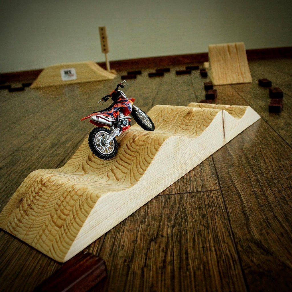 Kids wooden motocross track designed for exciting miniature dirt bike races, featuring a large racing course with multiple obstacles.